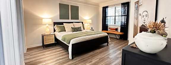 a bedroom with a bed and a ceiling fan at Grand Villas Apartments, Katy