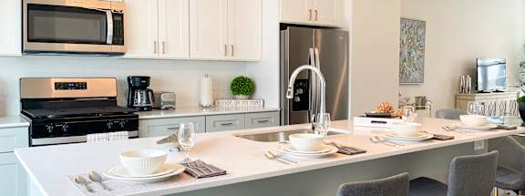 a kitchen with a counter top and chairs at Enclave Crystal Lake Townhomes and Apartments, Illinois, 60014