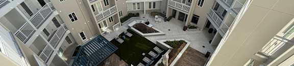 A top-down view of a courtyard surrounded by apartment buildings.
