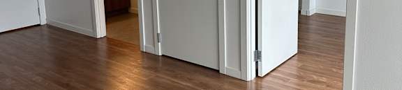 A white cabinet with a drawer is open, revealing a small light-colored interior.