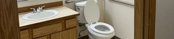 A view from below looking up at a toilet in a small room.