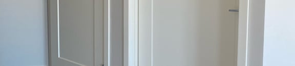 A white ceiling with two open and one closed ventilation shelves.