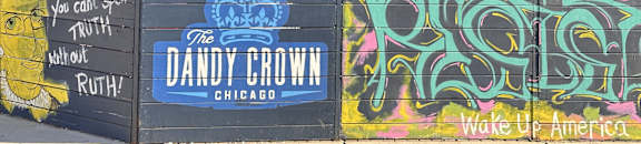 A mural on a wall with the words "Dandy Crown" and "Wake Up America" written on it.