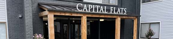 the front entrance of capital flats apartments at Capital Flats & Magnolia Square Apartments, North Carolina
