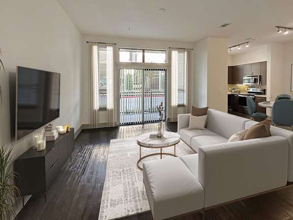 A modern living room with a white couch and a flat screen TV.