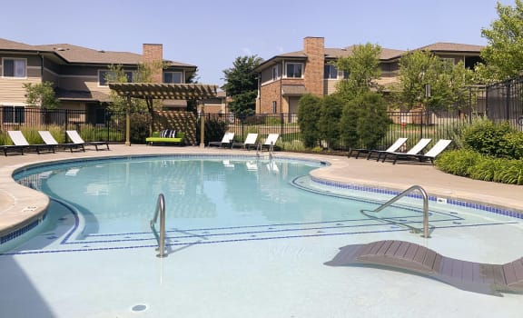 Resort style swimming pool with sun tanning loungers at North Pointe  Villas Lincoln Nebraska