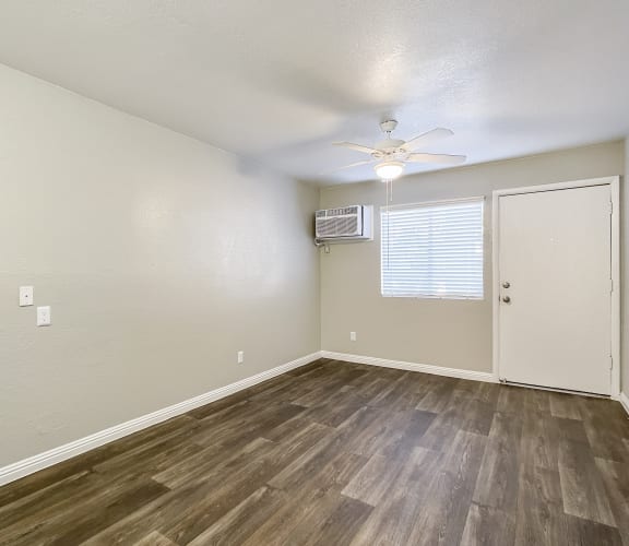 a bedroom with hardwood floors and a ceiling fan at Valencia Park, Phoenix