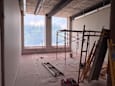 A room under construction with scaffolding and construction materials.