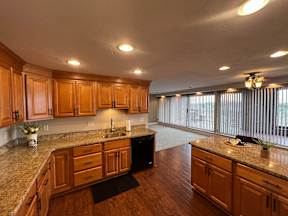 A kitchen with wooden cabinets and granite countertops.