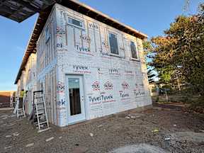 A house under construction with Tyvek branded insulation on the exterior walls.