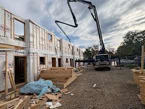 A construction site with a crane and a building under construction.