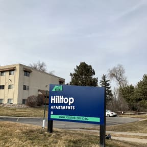 a blue and green sign on the side of a building