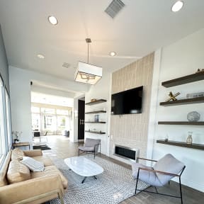 a club room with a couch and a tv in a loft at The Bryant Apartments at Yorba Linda, Yorba Linda, 92887