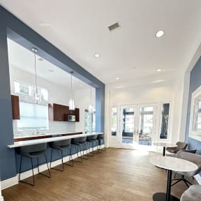a living room with a glass floor and a table and chairs at The Bryant Apartments at Yorba Linda, Yorba Linda