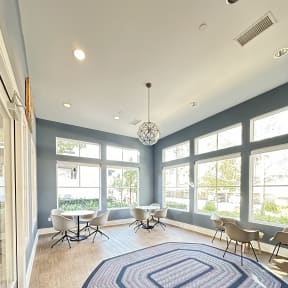 a sitting area in a clubhouse with rug and chairs at The Bryant Apartments at Yorba Linda, Yorba Linda, CA