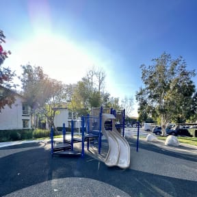 a park with multiple slides at The Bryant Apartments at Yorba Linda, California