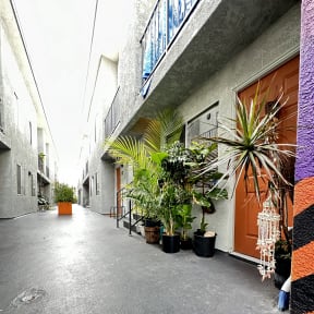 an overhead view of a building with plants in it at The Marq Apartments LLC, Los Angeles, California