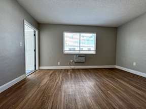 an empty room with a window and a wood ceiling  at Palm Gardens @ Biscayne Gardens, North Miami, FL