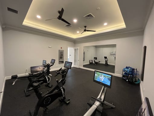 a room with a lot of exercise equipment
