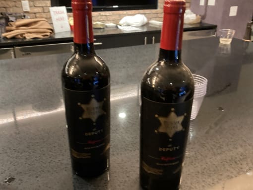 two bottles of wine sitting on a counter