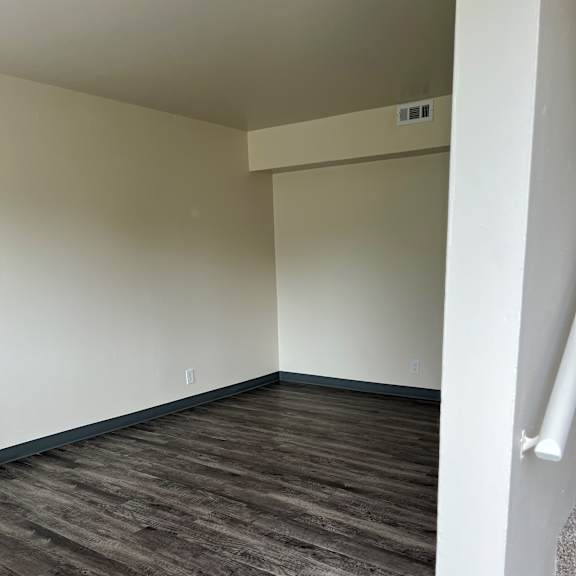 a view of the bottom of a room with a wooden wall and a white counter