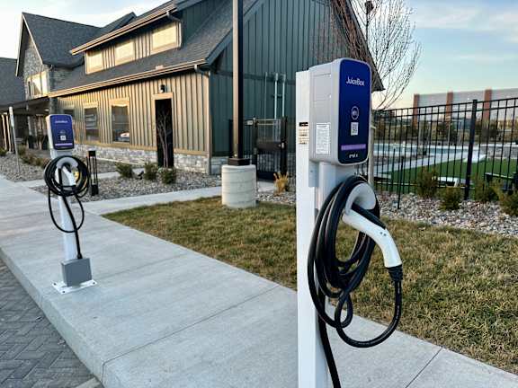 a charging station for electric vehicles outside of a house at The Depot Luxury Apartment Homes, Raymore, MO