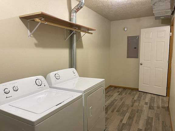 A small laundry room with a washer and dryer.