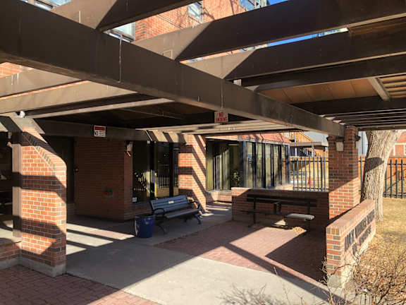 A brick building with a covered walkway.