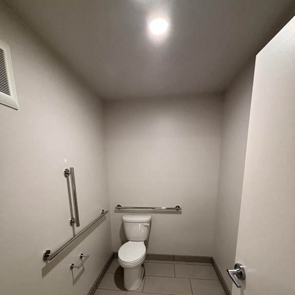 A bathroom with a toilet and a sink.