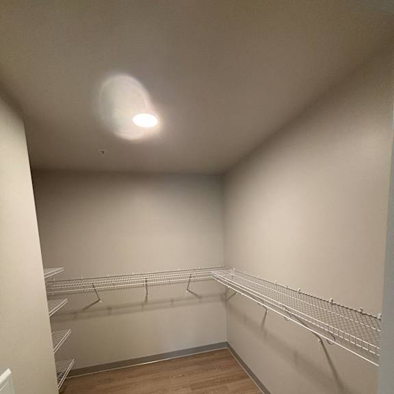 A room with a wooden door and a white ceiling.