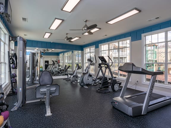 A spacious gym with a variety of equipment including treadmills, weights, and exercise machines.