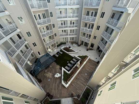 A top-down view of a courtyard surrounded by apartment buildings.