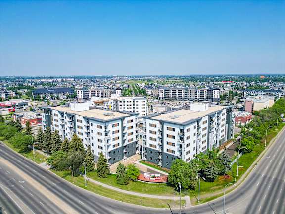A Large Building With Trees On The Side at Cadence at Griesbach, Alberta, T5E 1Y8
