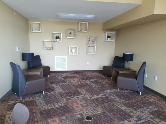a waiting room with chairs and pictures on the wall