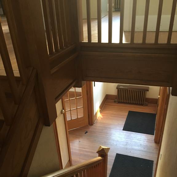 A wooden staircase leads up to a second floor.