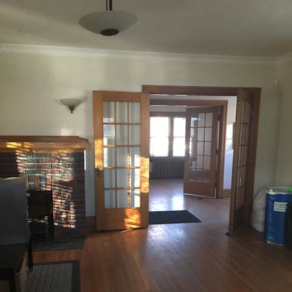 A room with a wooden ceiling and a window with blinds.