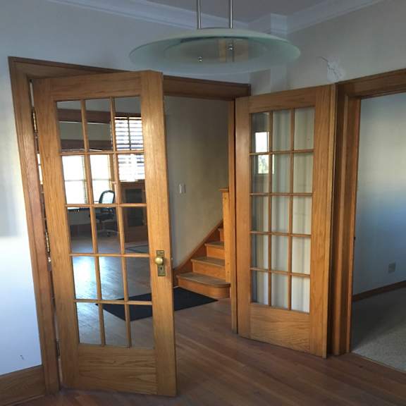 A wooden window with a white frame is open.
