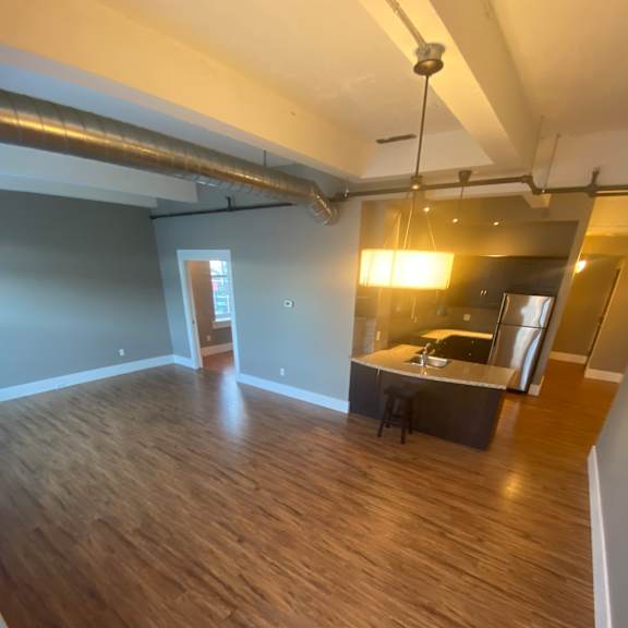 A large family room with an open concept kitchen.