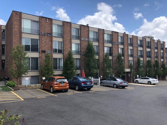 a large brick building with a parking lot in front of it