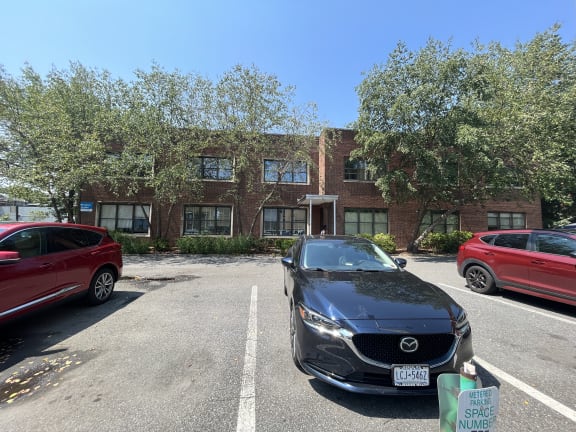 a large brick building with a parking lot in front of it