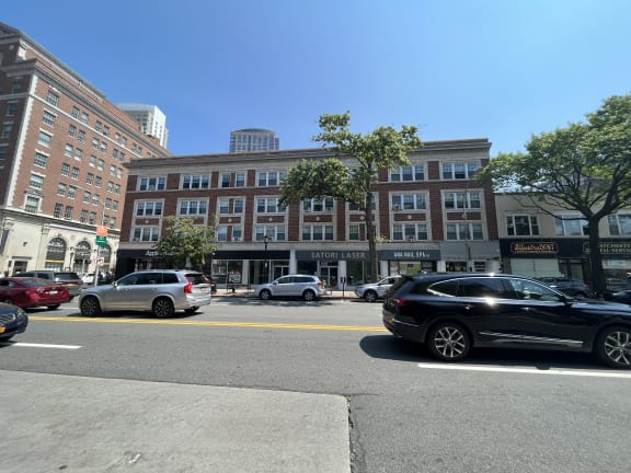 a large brick building with cars parked in front of it