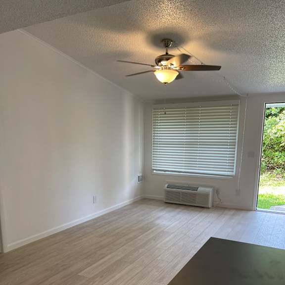 A bathroom with a window and a radiator.