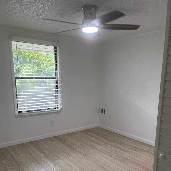 A ceiling fan is mounted on a white ceiling.