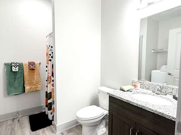 A white toilet sits next to a sink in a bathroom.