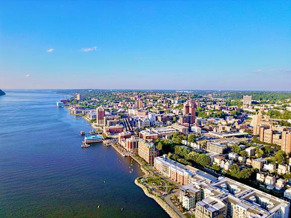 an aerial view of the city with the water and the city skyline