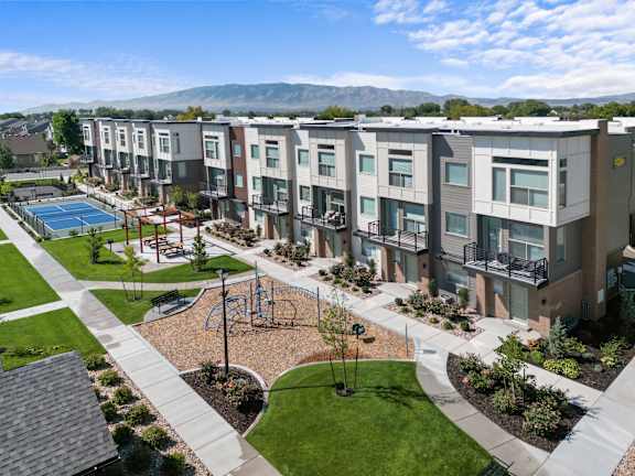 Apartment complex with a playground and a pool.