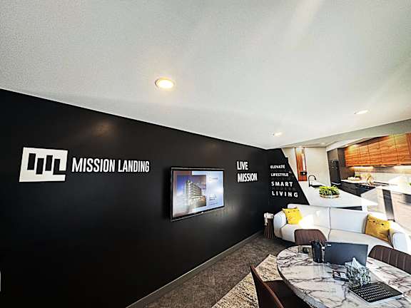 A modern living room with a black wall and a white couch.