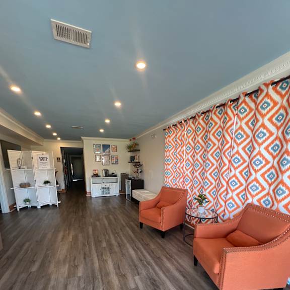 A kitchen with a wooden floor and a patterned ceiling.