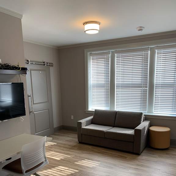 a small office with a desk and a window