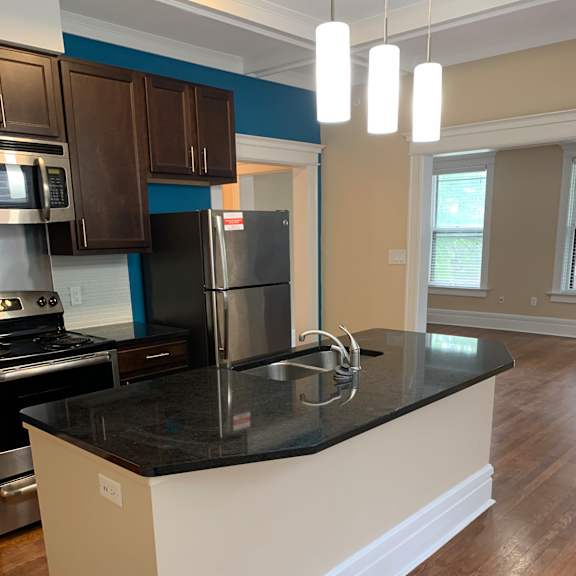 a kitchen with a long counter top and a sink